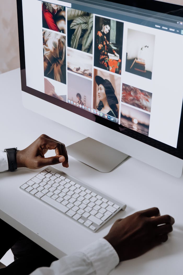 hero Man working on computer in modern office, viewing photography website. Clean and tech-focused environment.